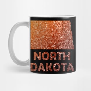 Colorful mandala art map of North Dakota with text in brown and orange Mug